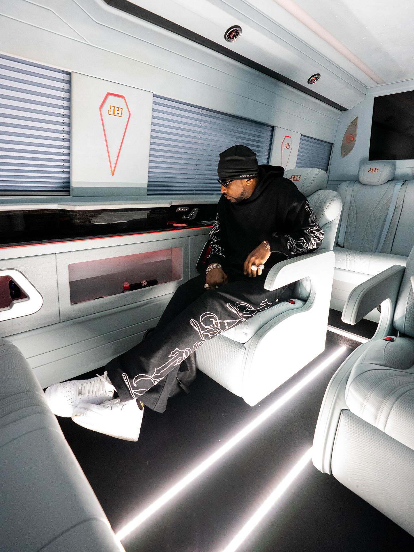 A guest seated in a white private cabin